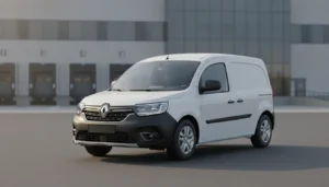Renault Kangoo Van blanc stationné devant un entrepôt logistique, vue 3/4 avant, lumière naturelle matinale